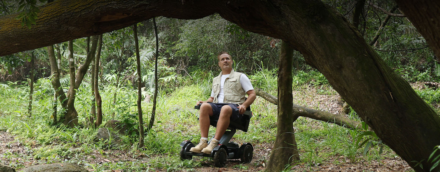 man sitting on wheelchair in the forest