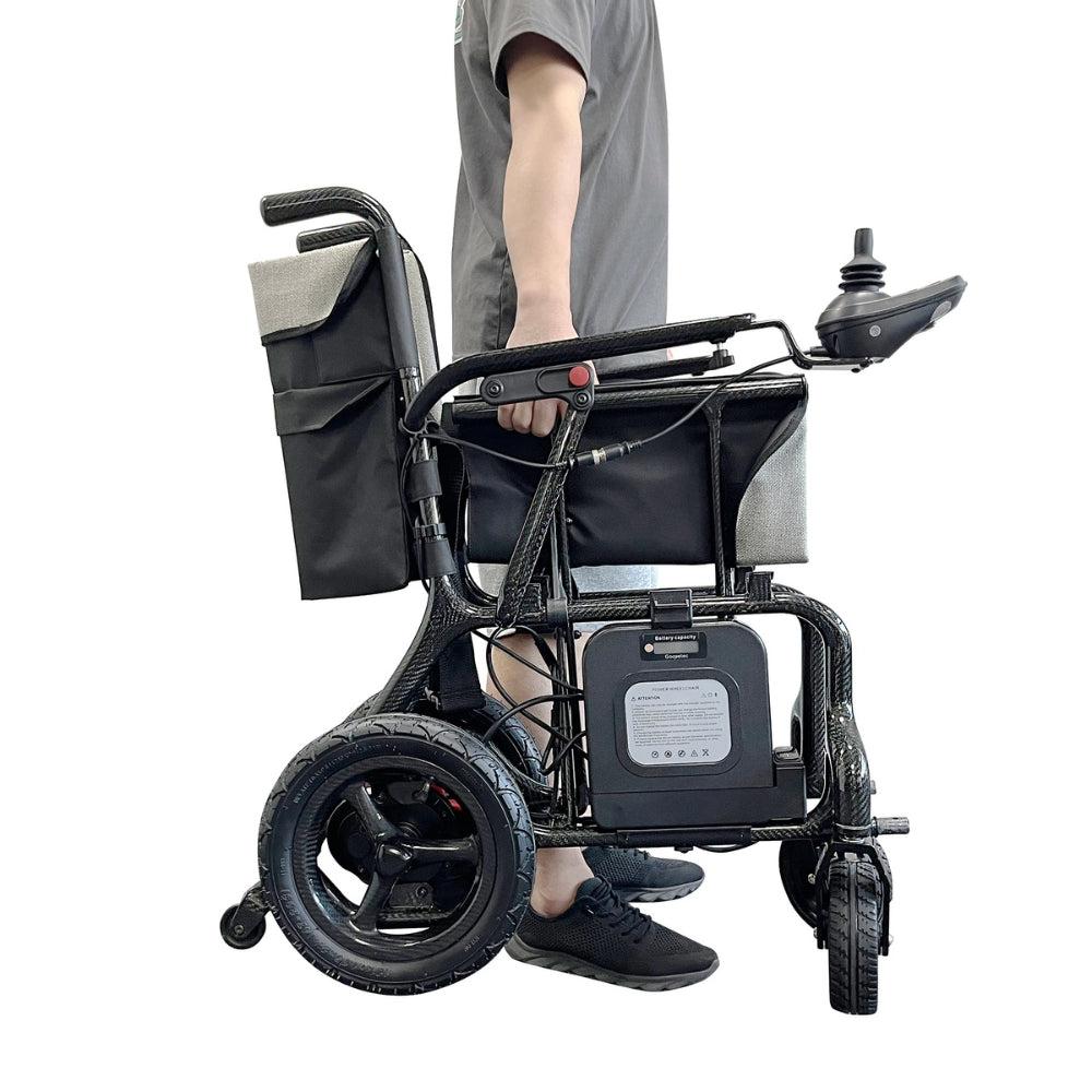 man holding carbon fibre electrical wheelchair 