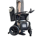 man holding carbon fibre electrical wheelchair 