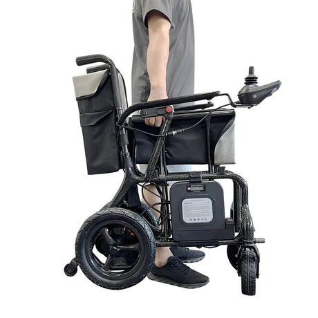 man holding carbon fibre electrical wheelchair 
