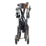 front view in compact folded position, showing folded frame and wheels. 